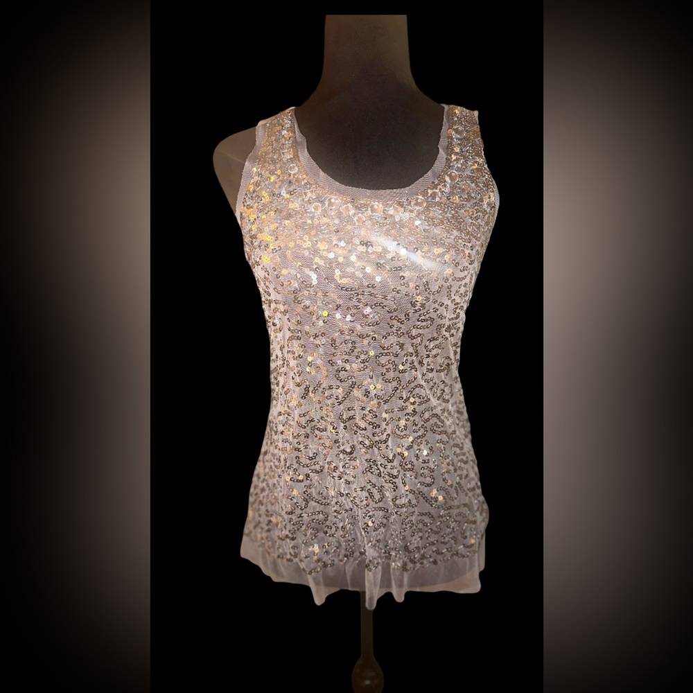 Sequined, sheer layered top
. Sparkles at every angle.